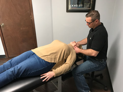 Chiropractor Granite City IL Jason Talley Adjusting Patient's Neck